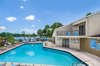 View of Swimming Pool, Sundeck, and Lake at Water's Edge Apartments, Sunrise, Florida